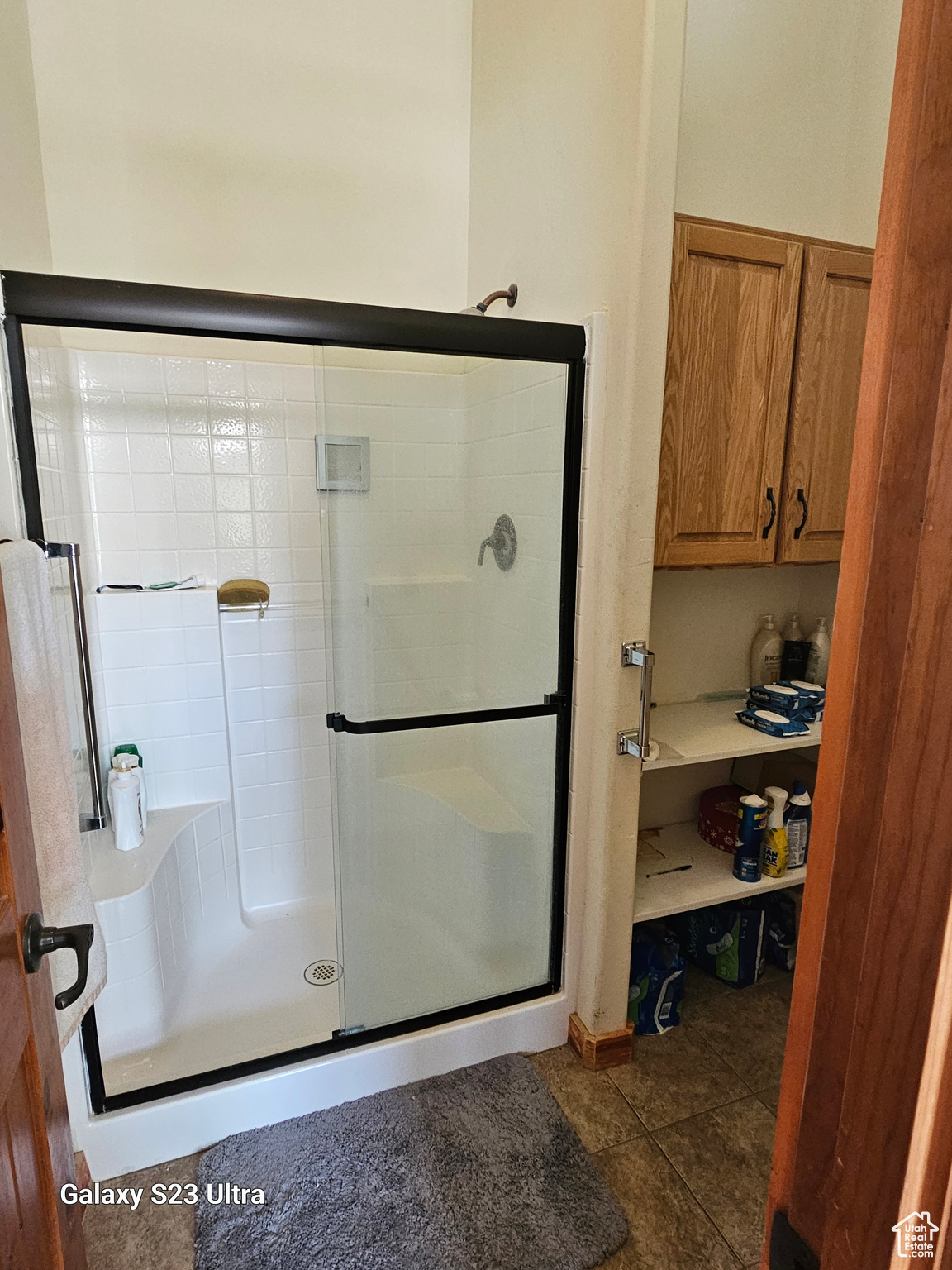 Bathroom with walk in shower and tile patterned flooring