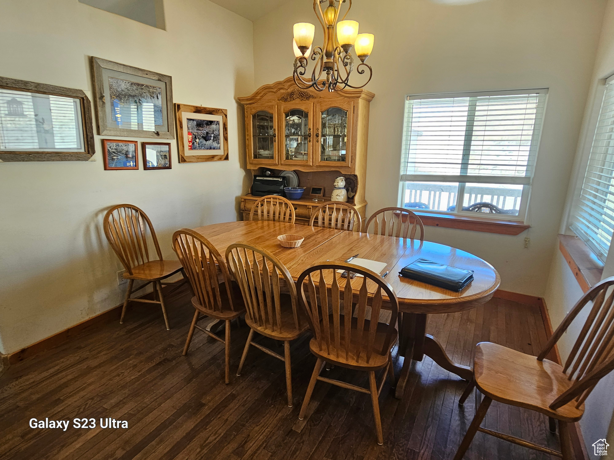 Dining area featuring a chandelier, wood-type flooring, and a wealth of natural light