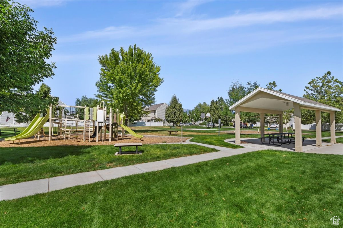 View of playground with a yard and a gazebo