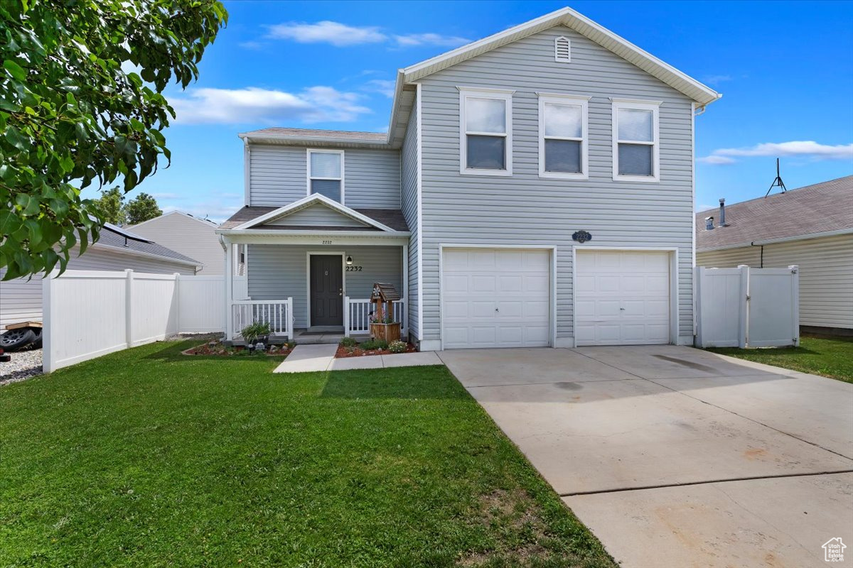 Front of property featuring a garage and a front lawn