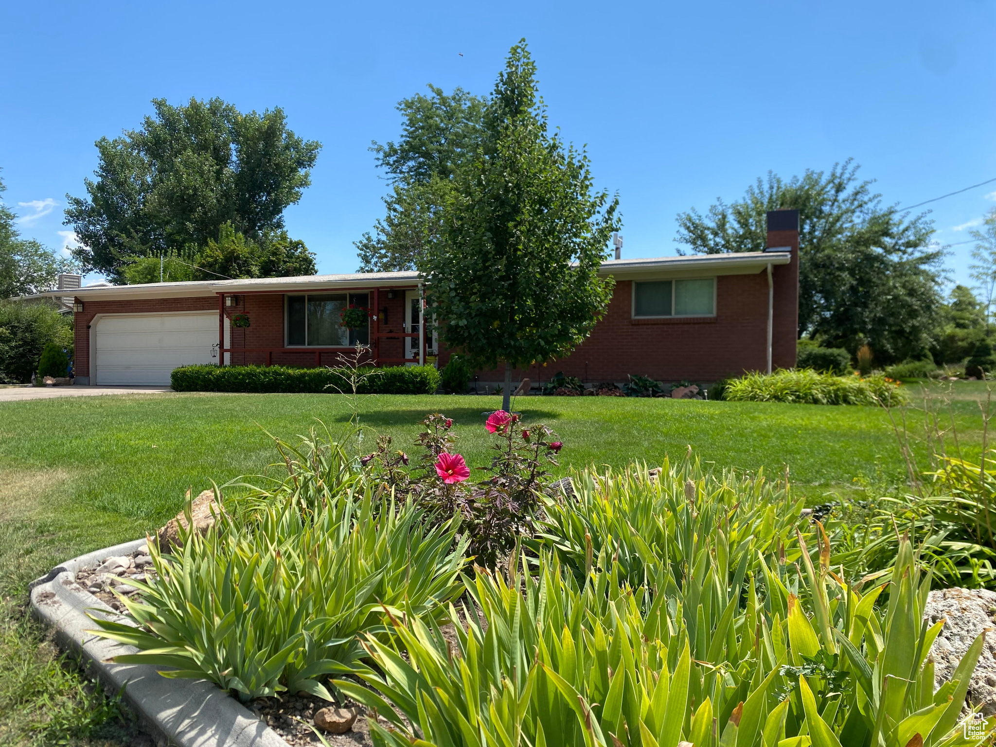 View of front of property with a garage and a front yard