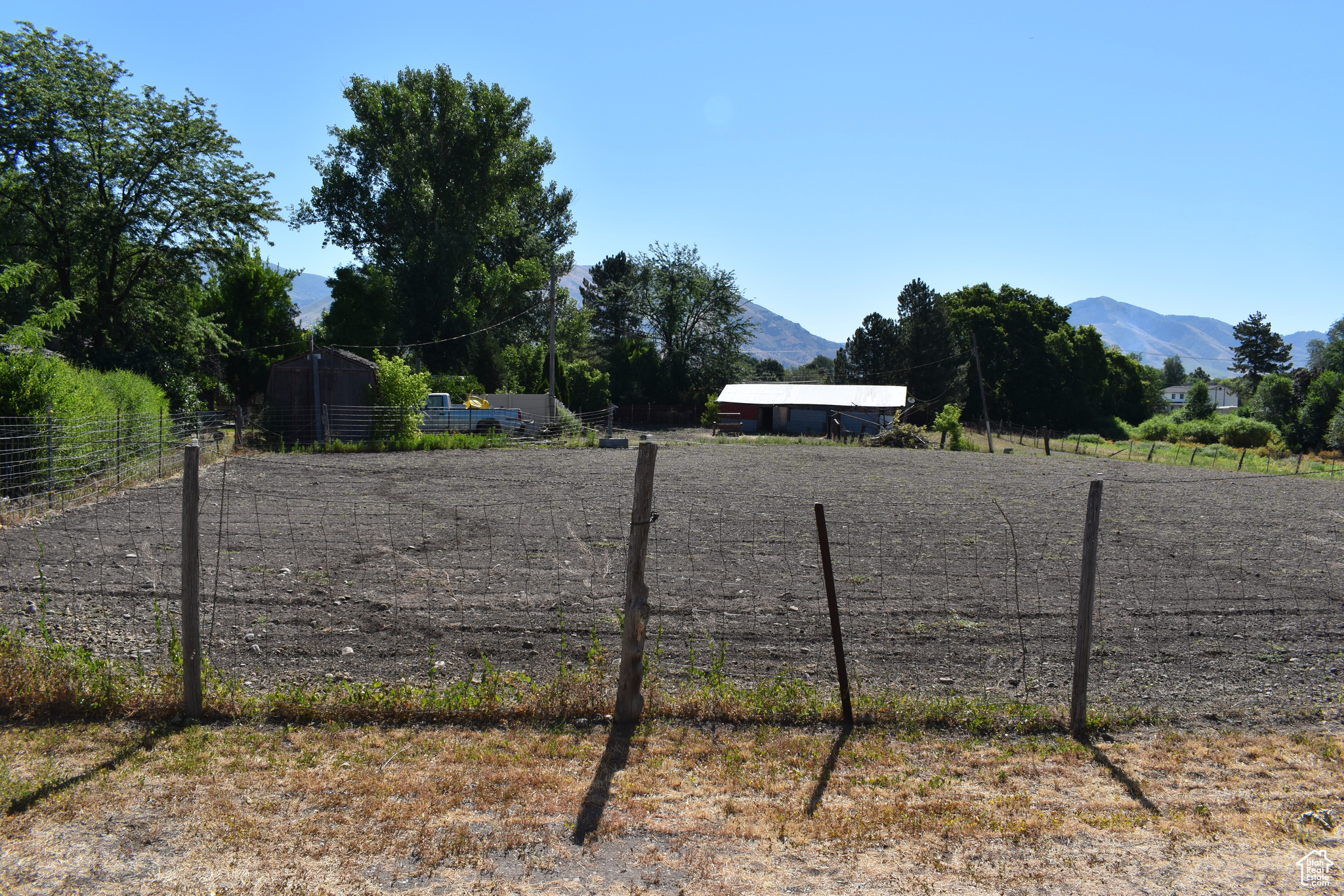 View of fenced horse pasture with a mountain view and a rural view