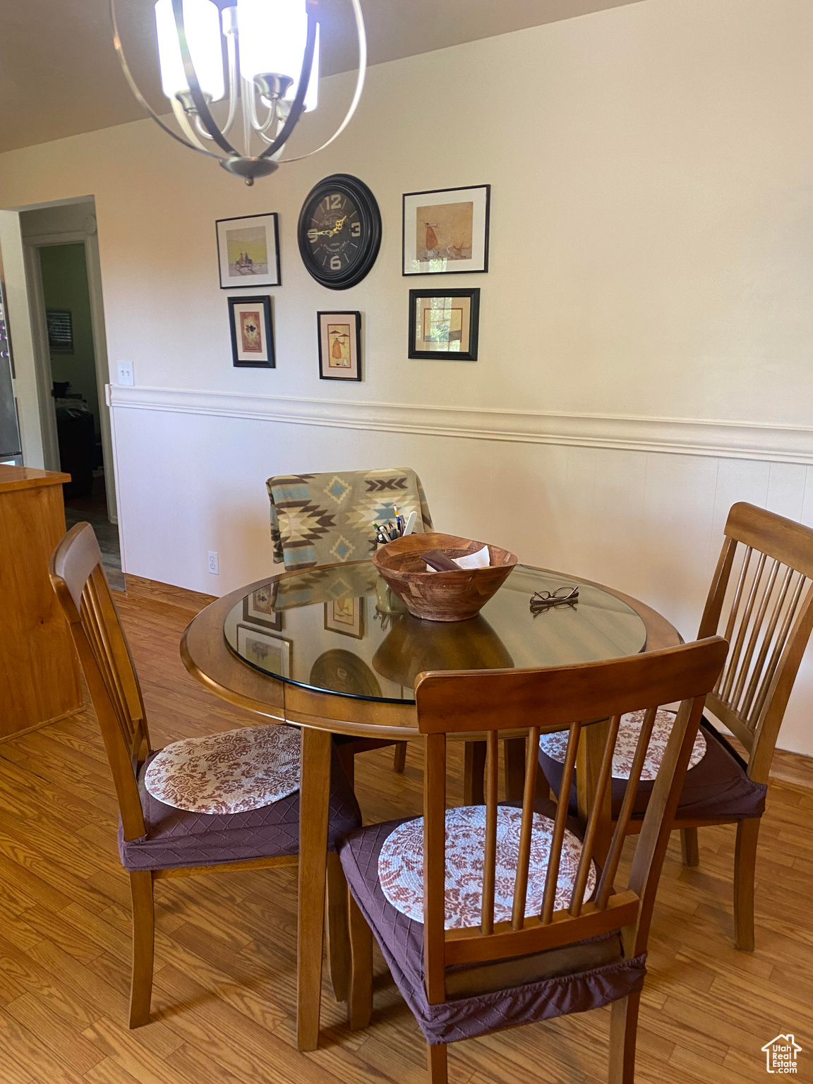 Dining space featuring light hardwood / wood-style floors and an inviting chandelier