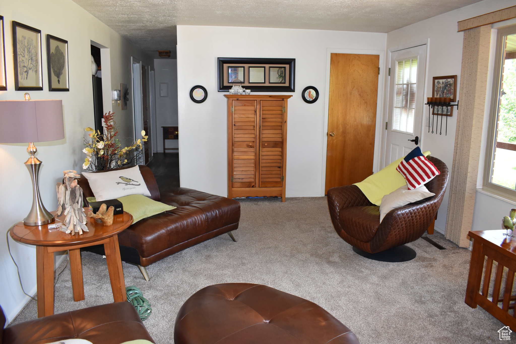 Carpeted living room with a textured ceiling