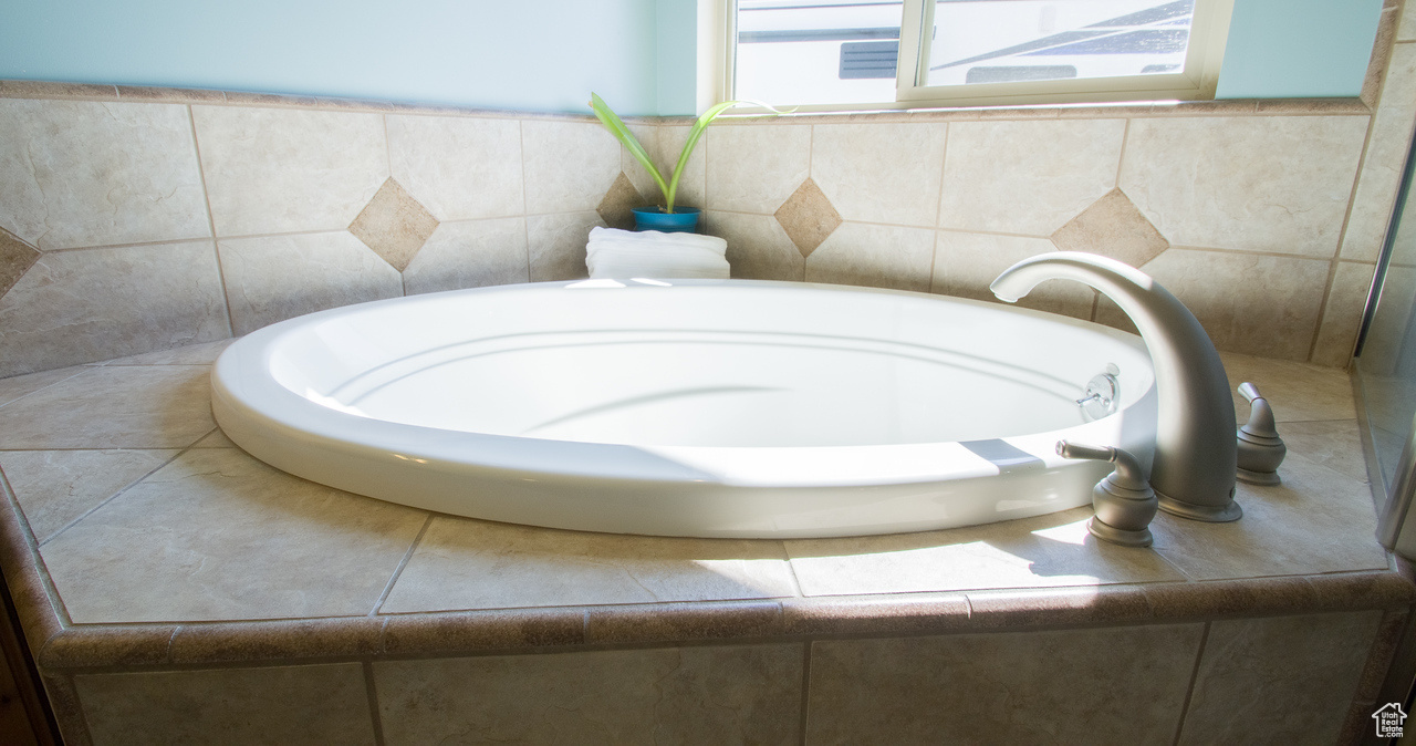 Primary Bathroom with a relaxing tiled tub