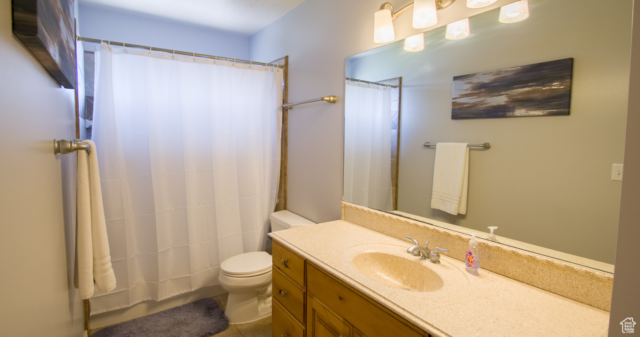 Bathroom featuring tile patterned floors, vanity, and toilet