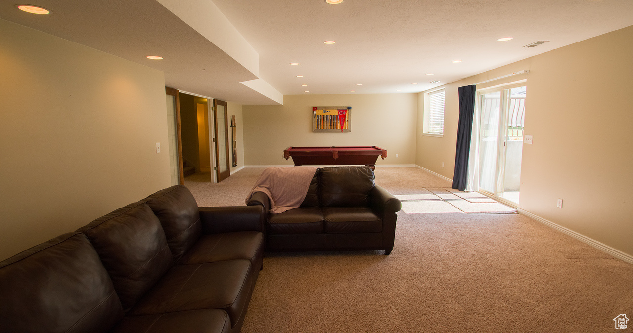 Living room featuring light colored carpet and billiards