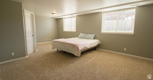 Bedroom with light colored carpet