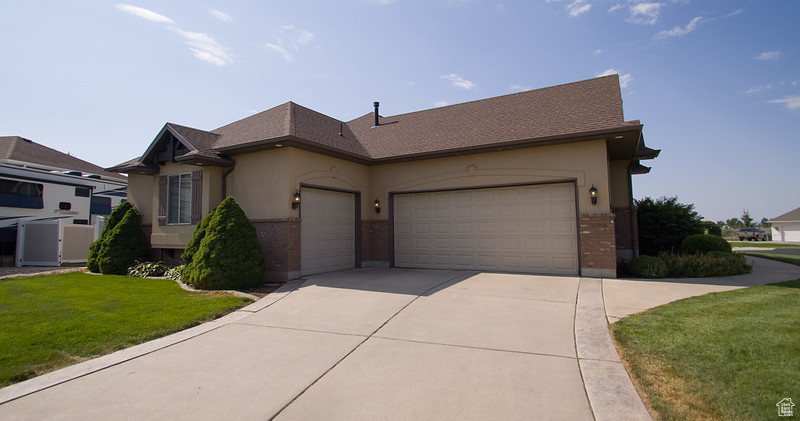 View of front of house with a garage and a front yard