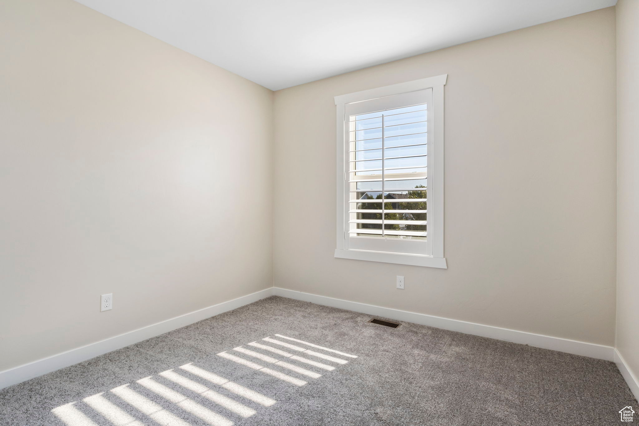 View of carpeted spare room