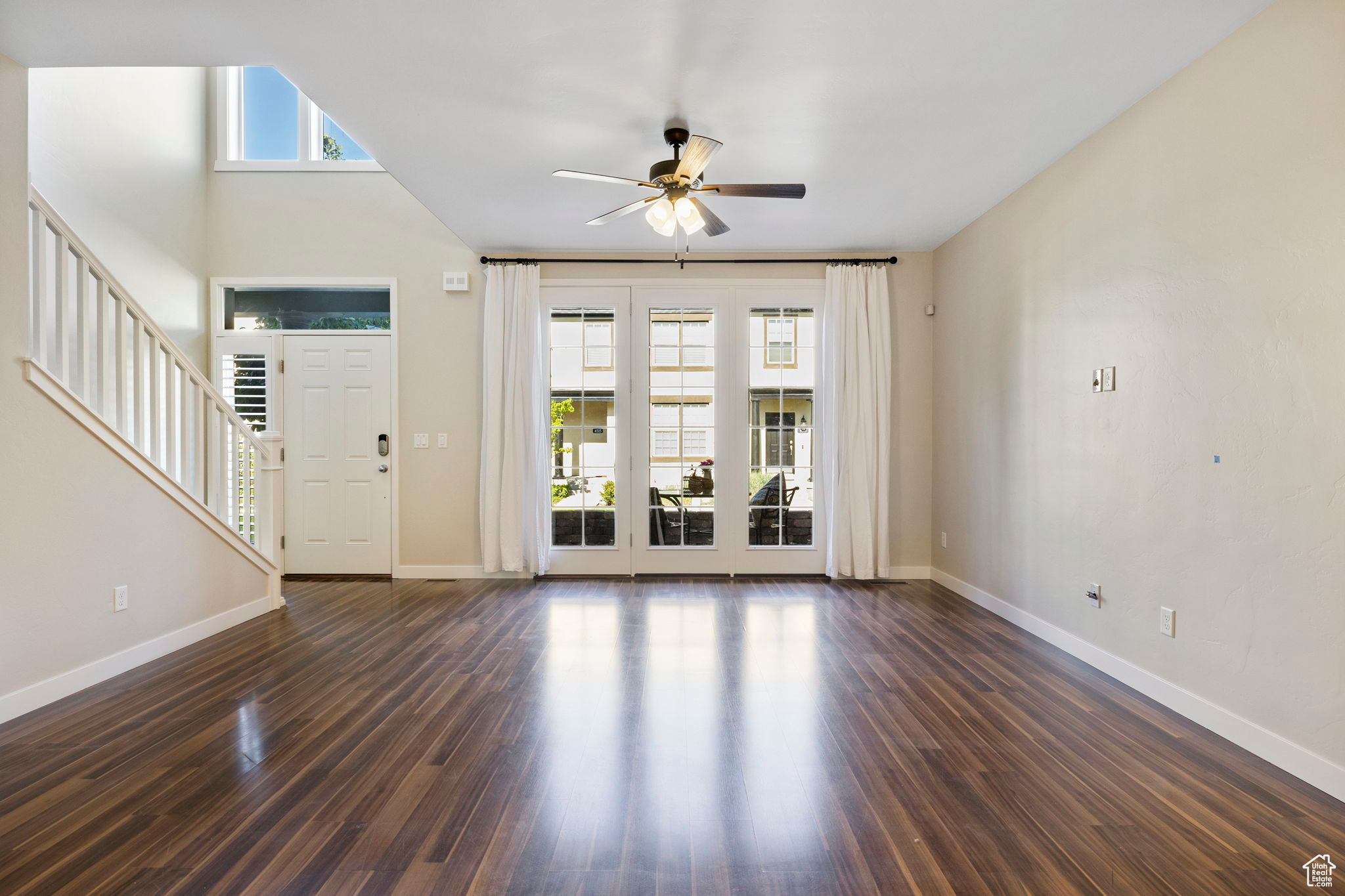 featuring a healthy amount of sunlight, ceiling fan, and hardwood / wood-style floors