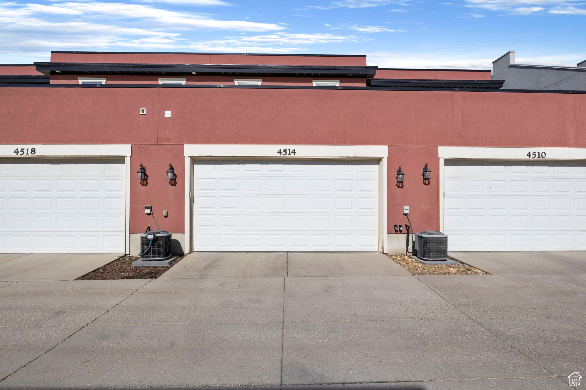 View of front of home with a garage and cooling unit