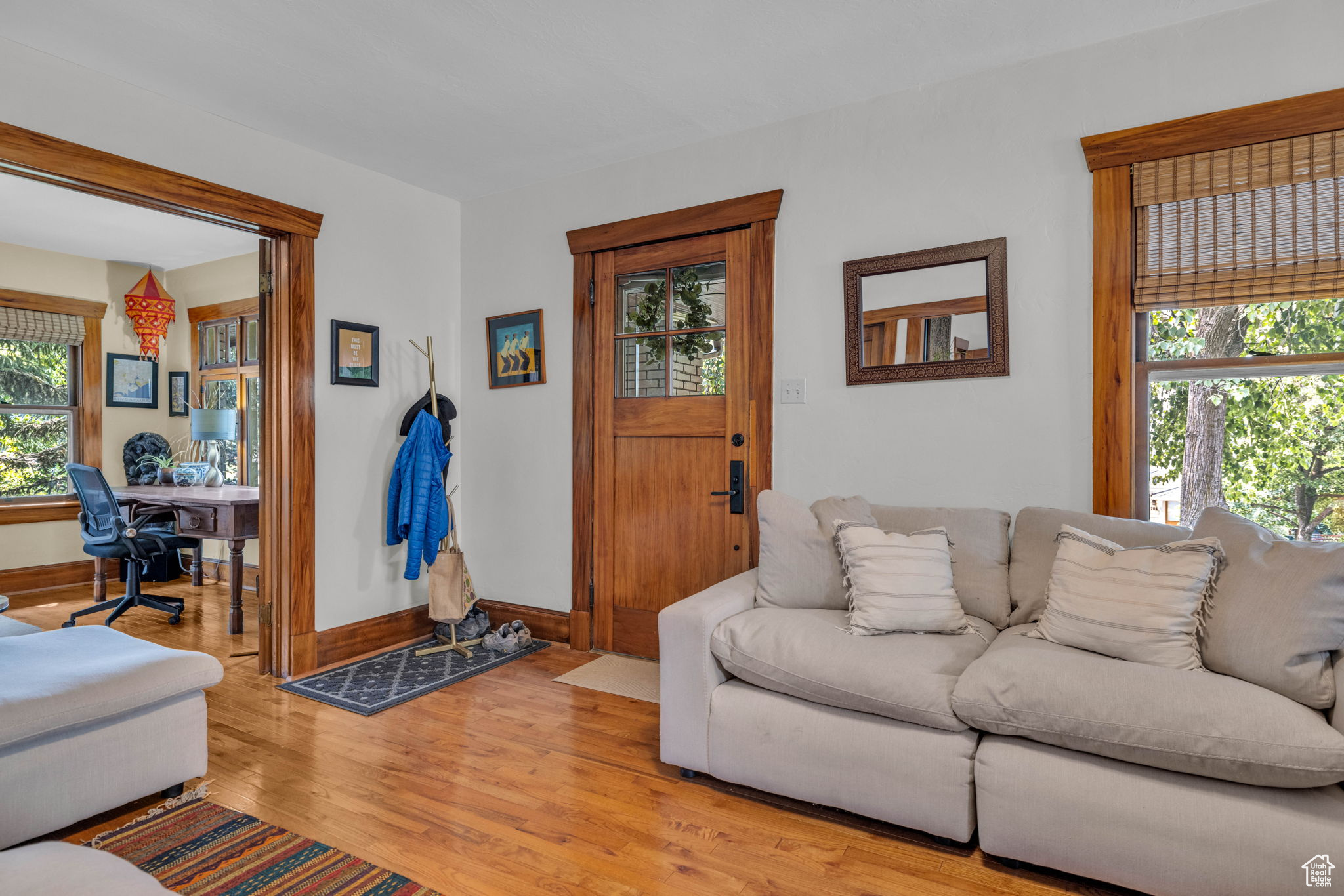 Living room with a wealth of natural light and light hardwood / wood-style floors