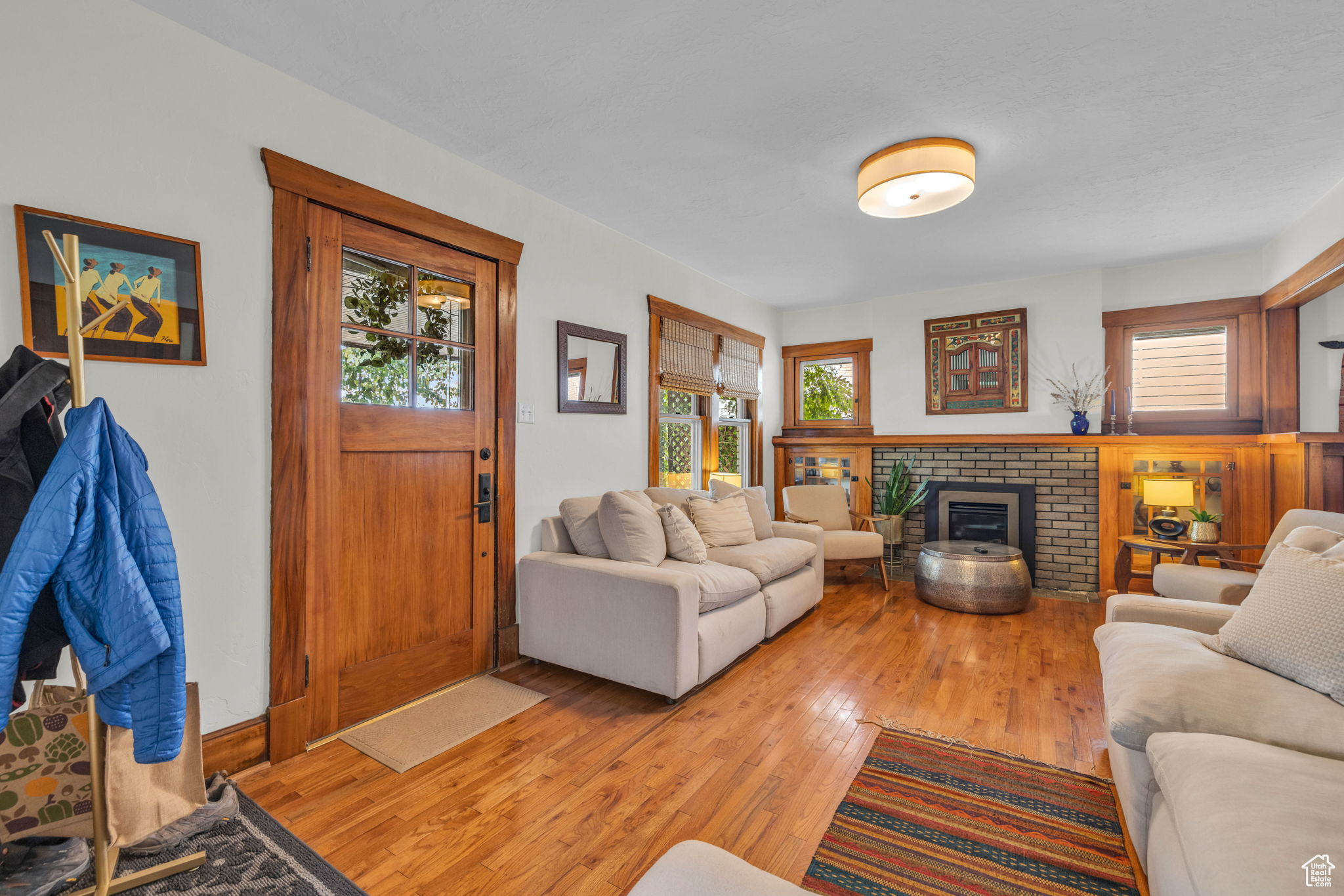 Living room with a fireplace, hardwood / wood-style flooring, and a healthy amount of sunlight