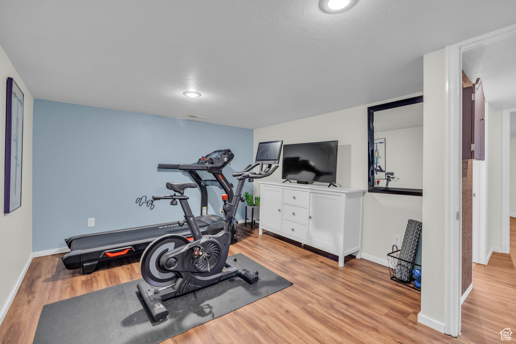 Workout area featuring light hardwood / wood-style flooring