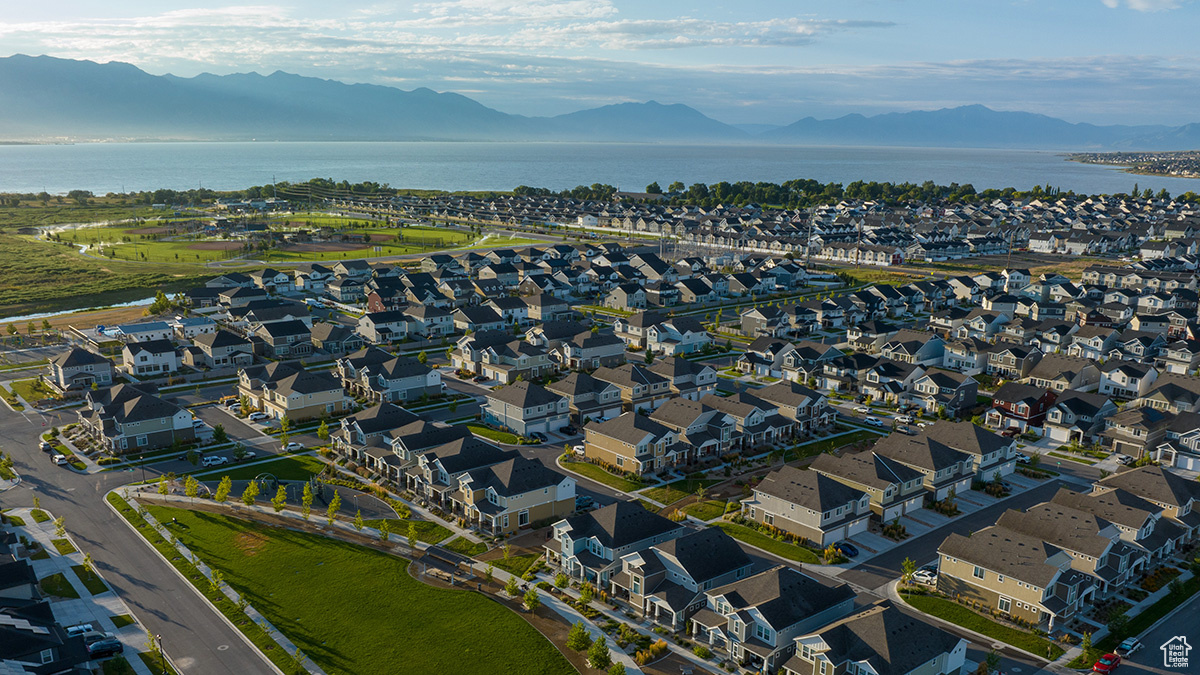 Birds eye view of property with a water and mountain view