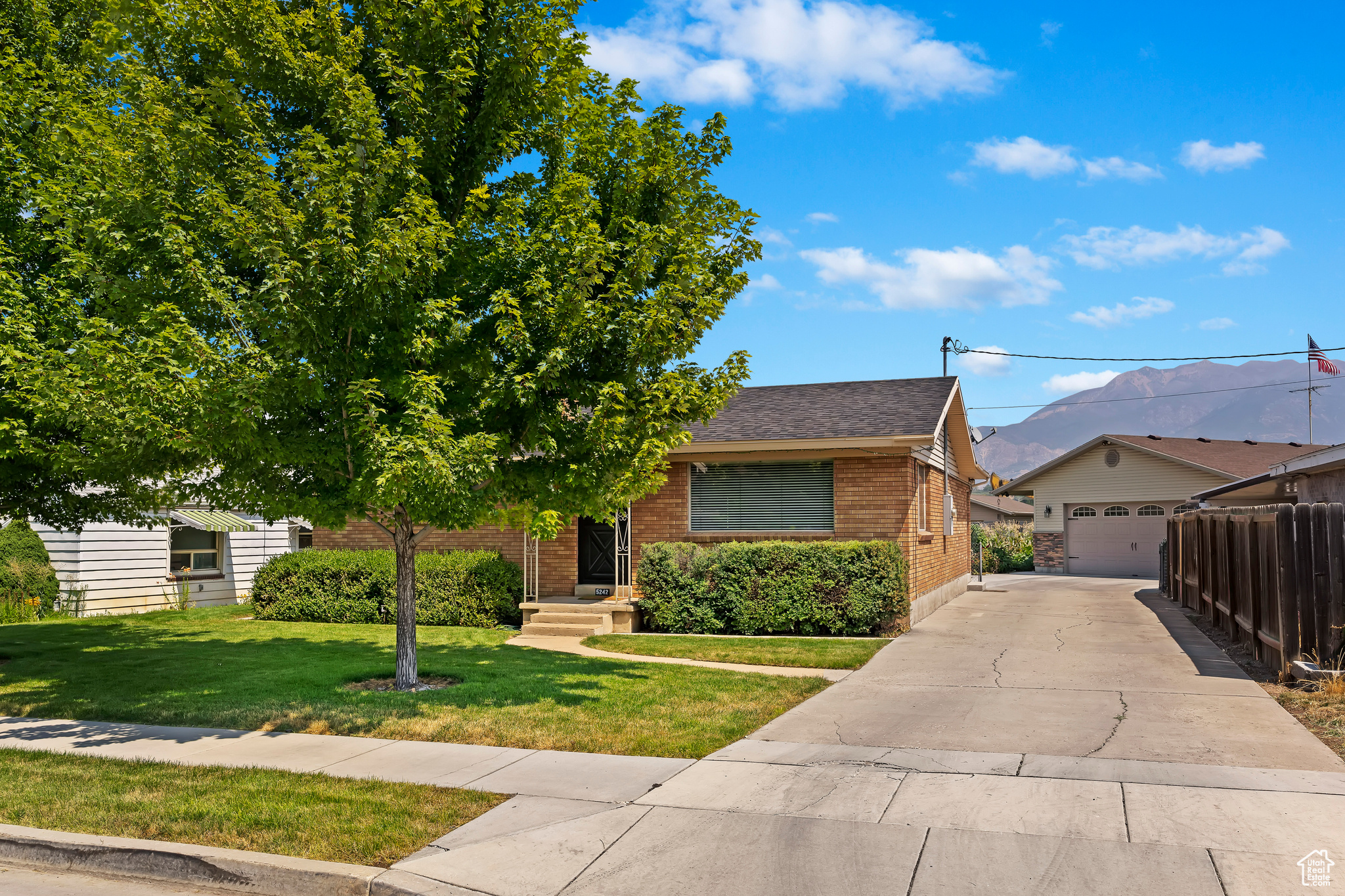 View of front of house with a front yard and a garage