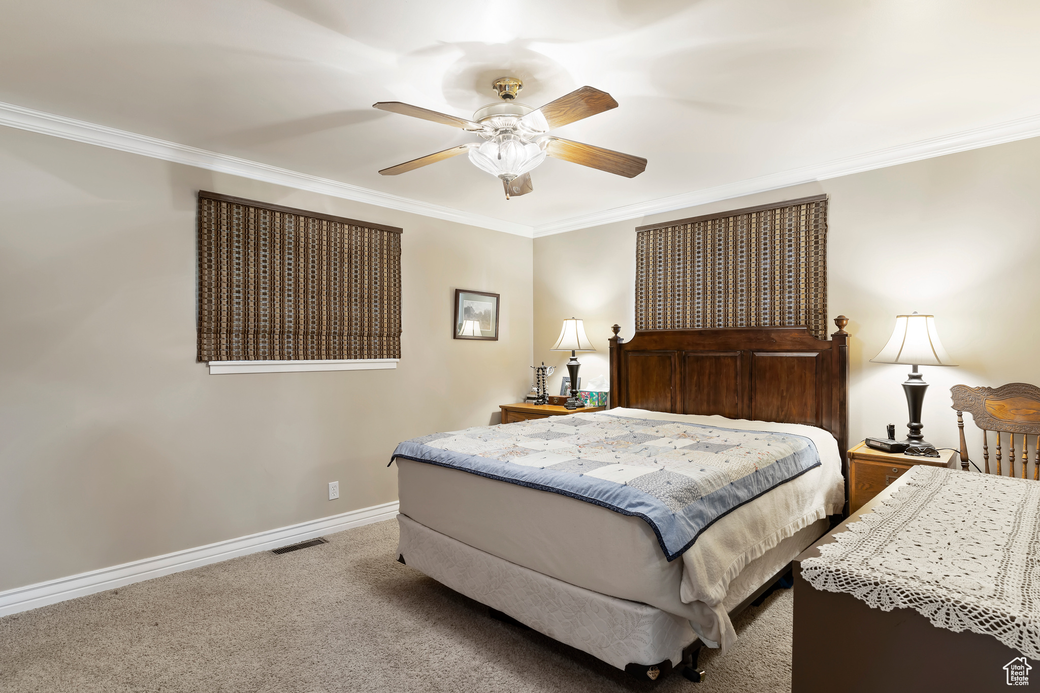 Bedroom featuring crown molding, ceiling fan, and carpet floors