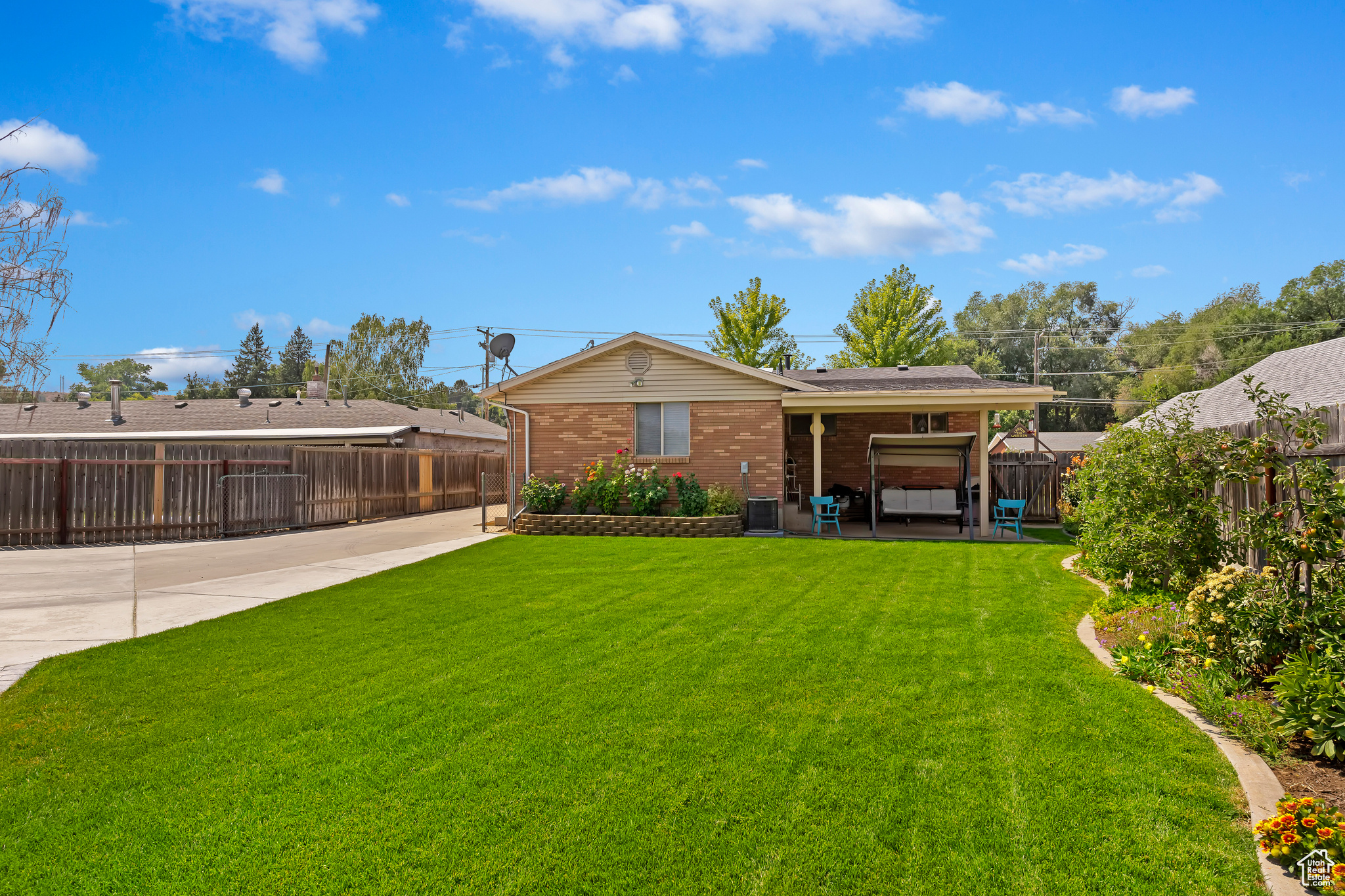 Back of house featuring a lawn and central AC unit