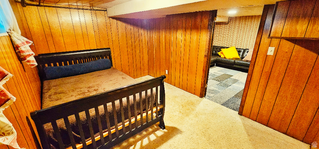 Bedroom featuring carpet and wooden walls