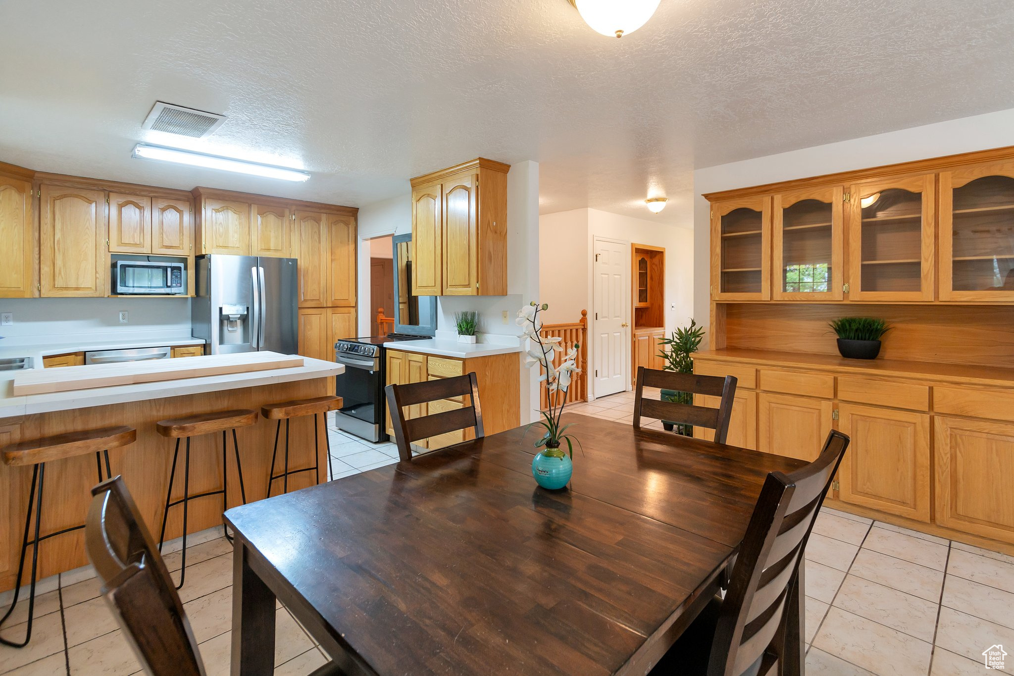 Tiled dining space with a textured ceiling