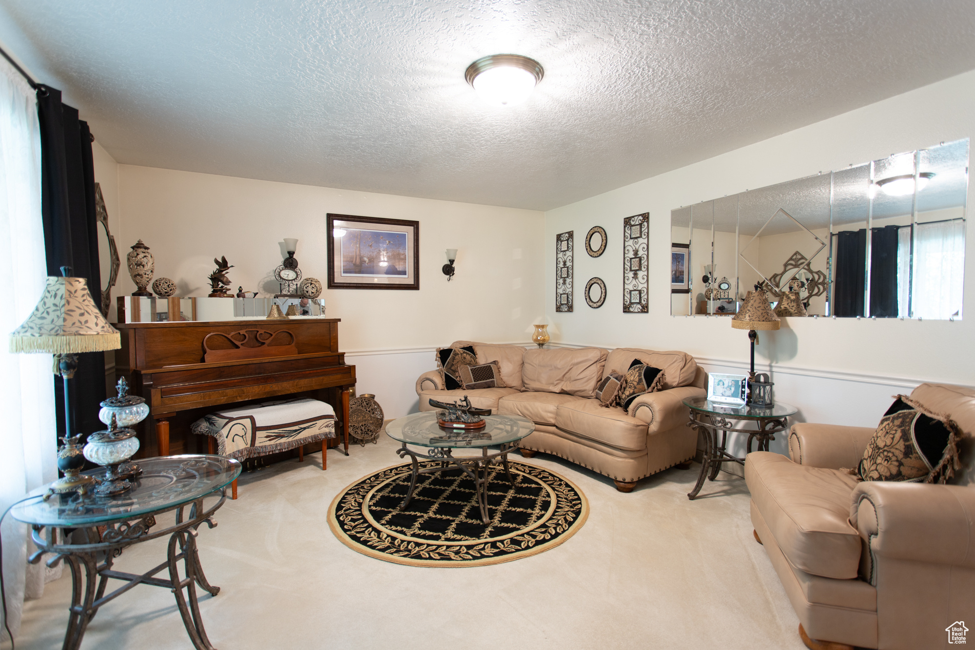 Carpeted living room with a textured ceiling