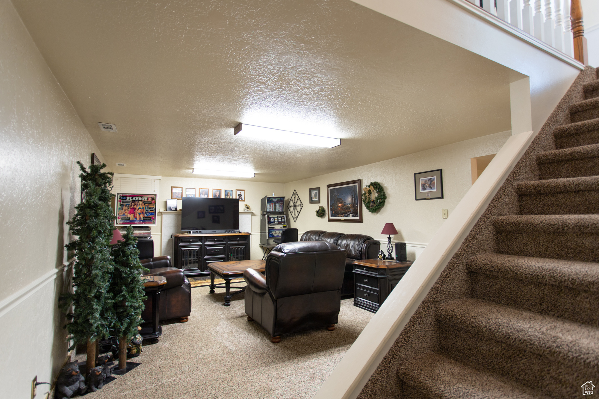 Carpeted living room with a textured ceiling