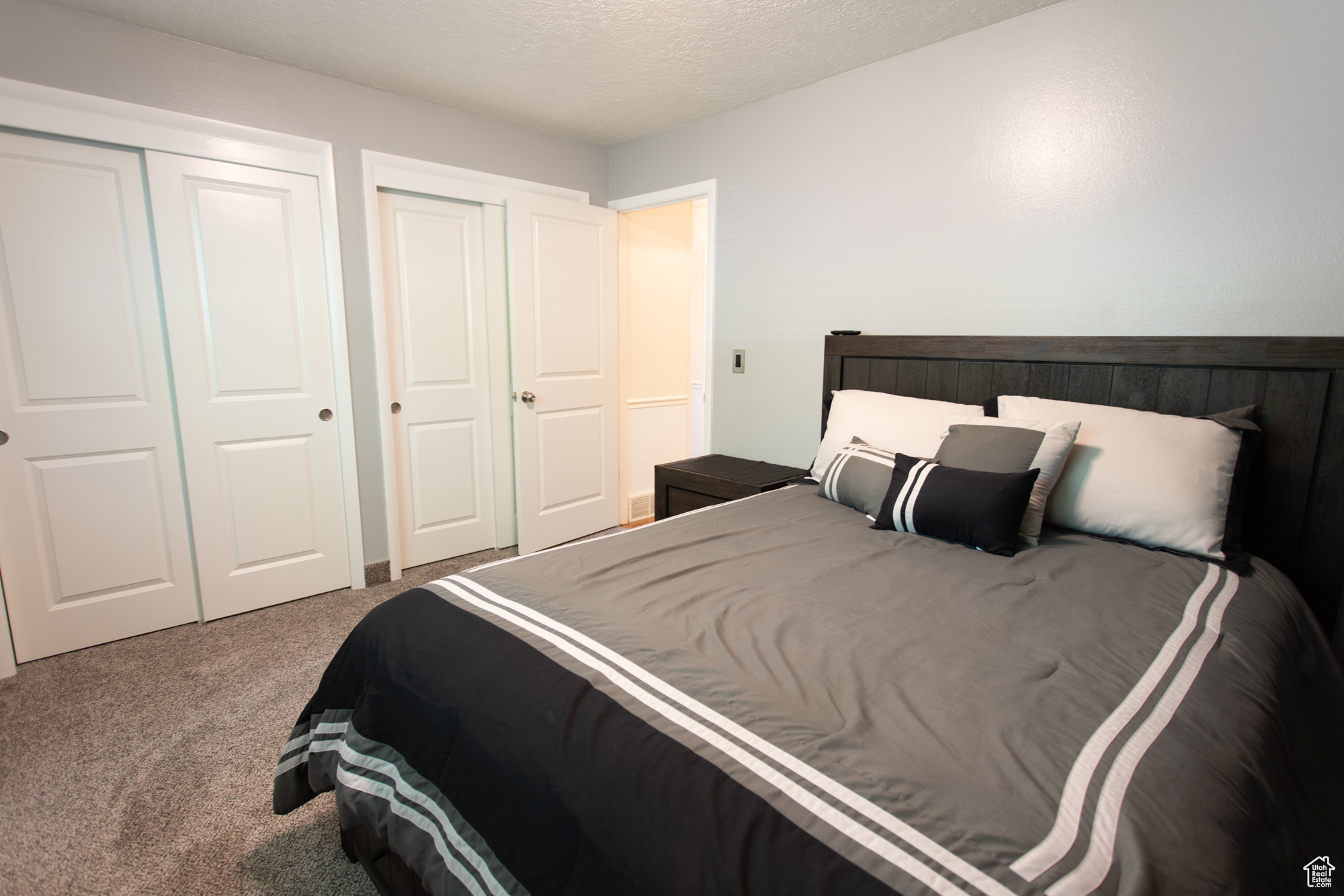 Carpeted bedroom with a textured ceiling