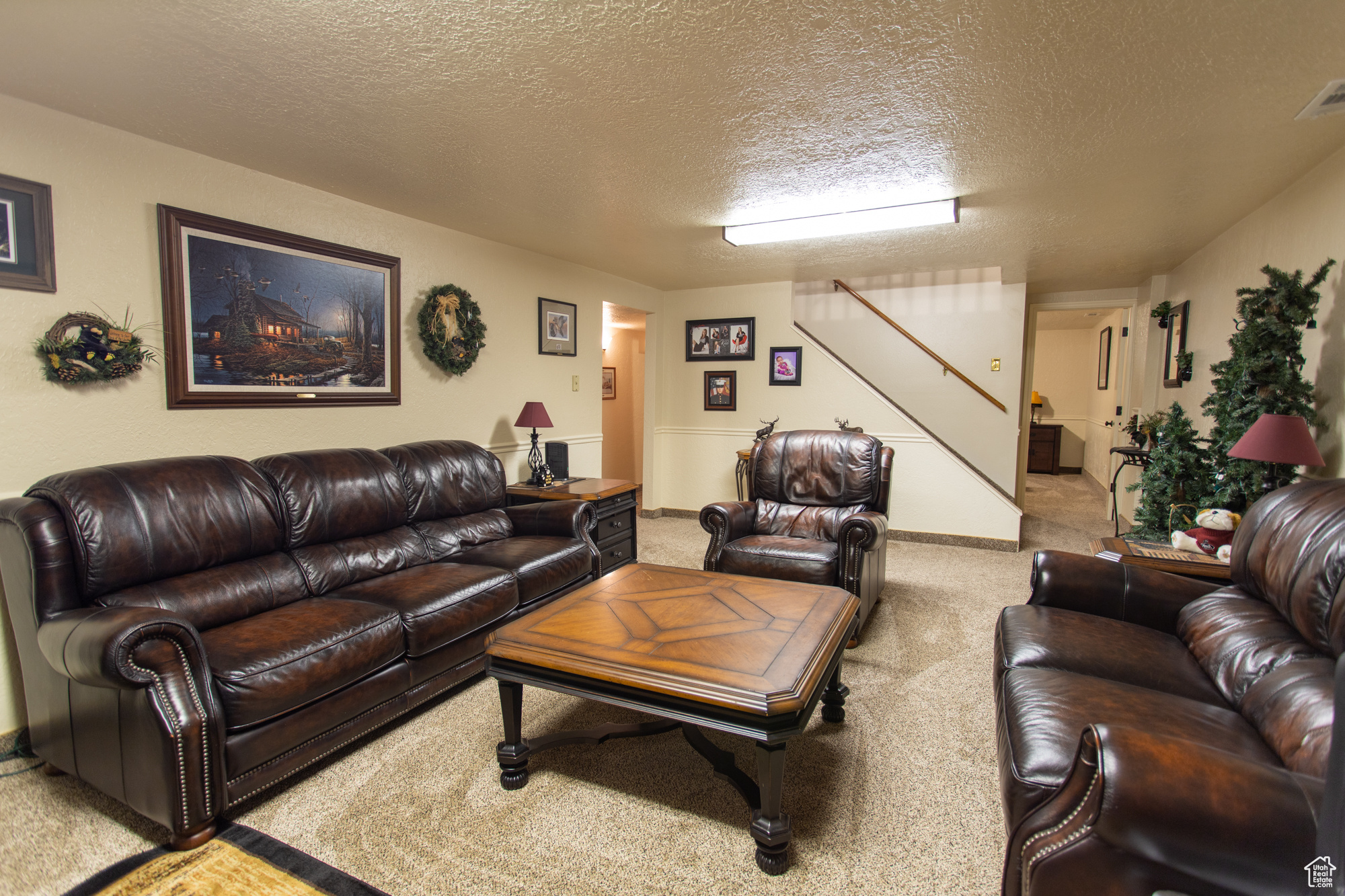 Carpeted living room with a textured ceiling