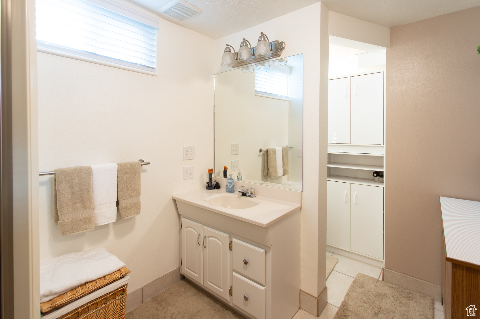 Bathroom featuring tile patterned floors and vanity