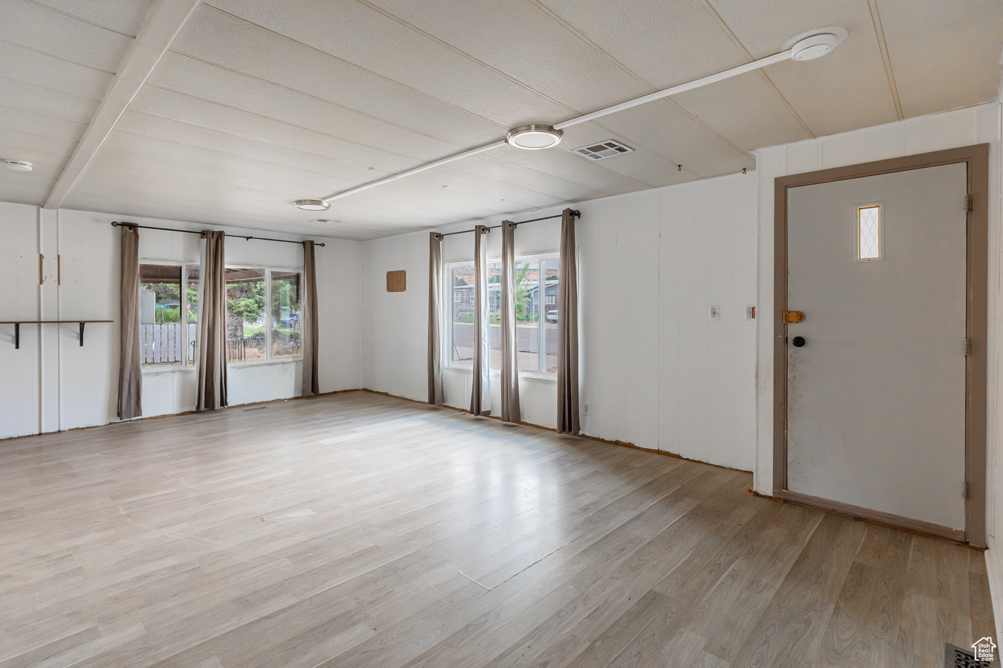 Interior space with light wood-type flooring and a wealth of natural light