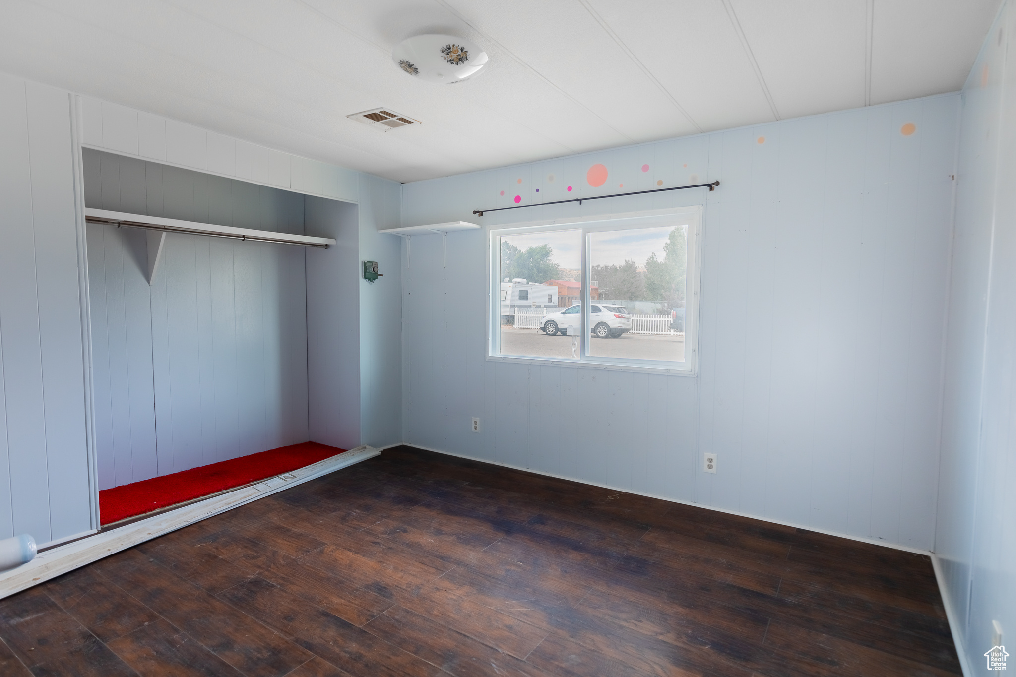 Unfurnished bedroom with hardwood / wood-style flooring and a closet