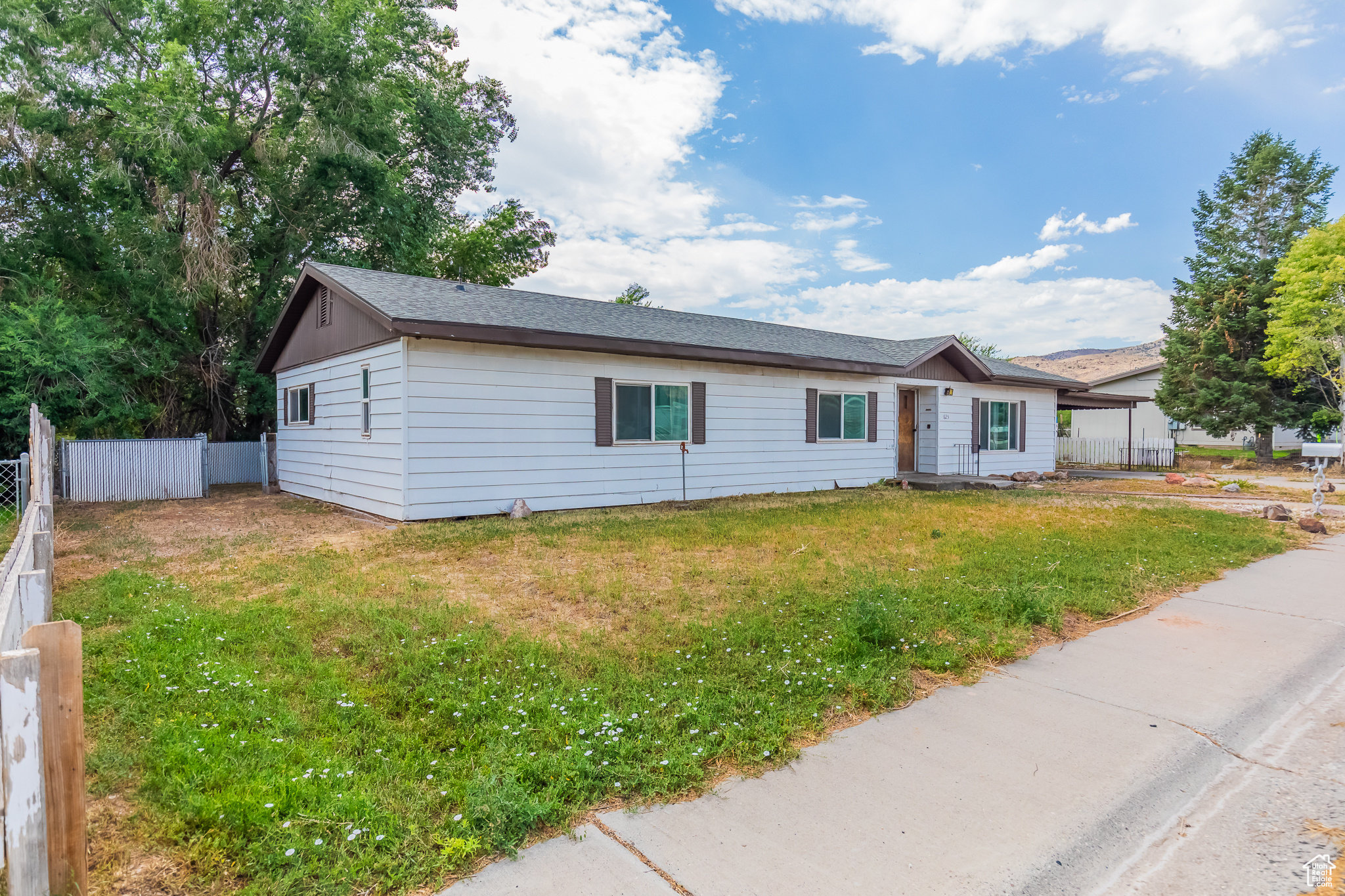 Ranch-style house with a front lawn