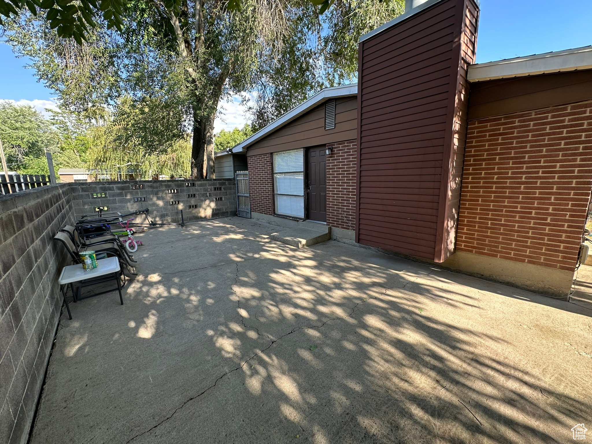 Large Patio on side of house with door to kitchen