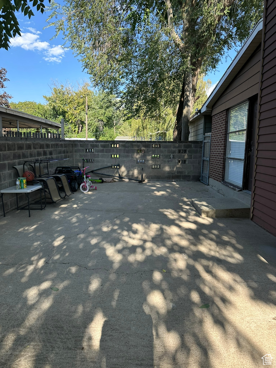 Large Patio on side of house with door to kitchen