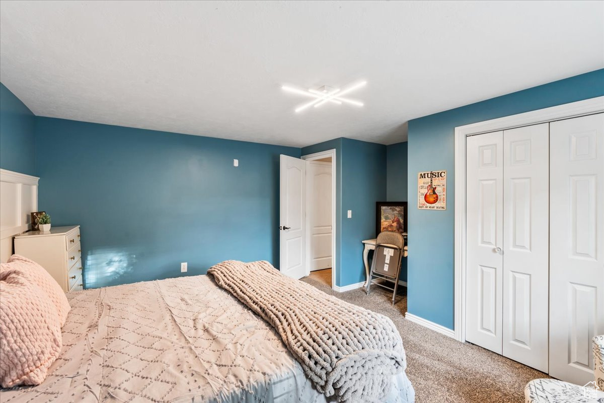 Carpeted bedroom with a closet