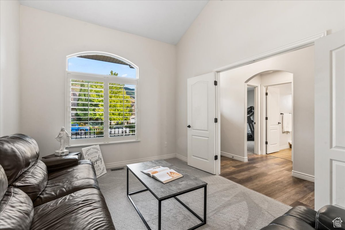 Living room featuring hardwood / wood-style floors and lofted ceiling