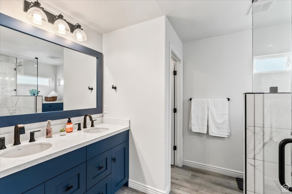 Bathroom with double sink vanity and hardwood / wood-style floors