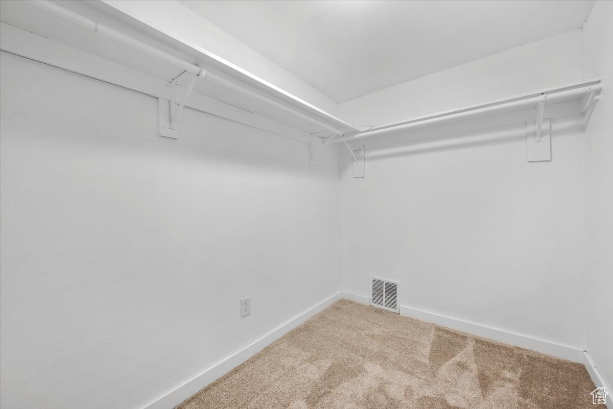 Walk in closet with carpet