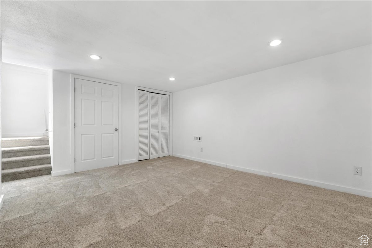 Unfurnished bedroom with two closets and light colored carpet