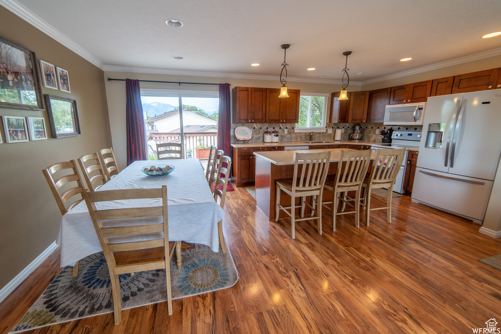 Dining room featuring ornamental molding, sink, and hardwood / wood-style flooring