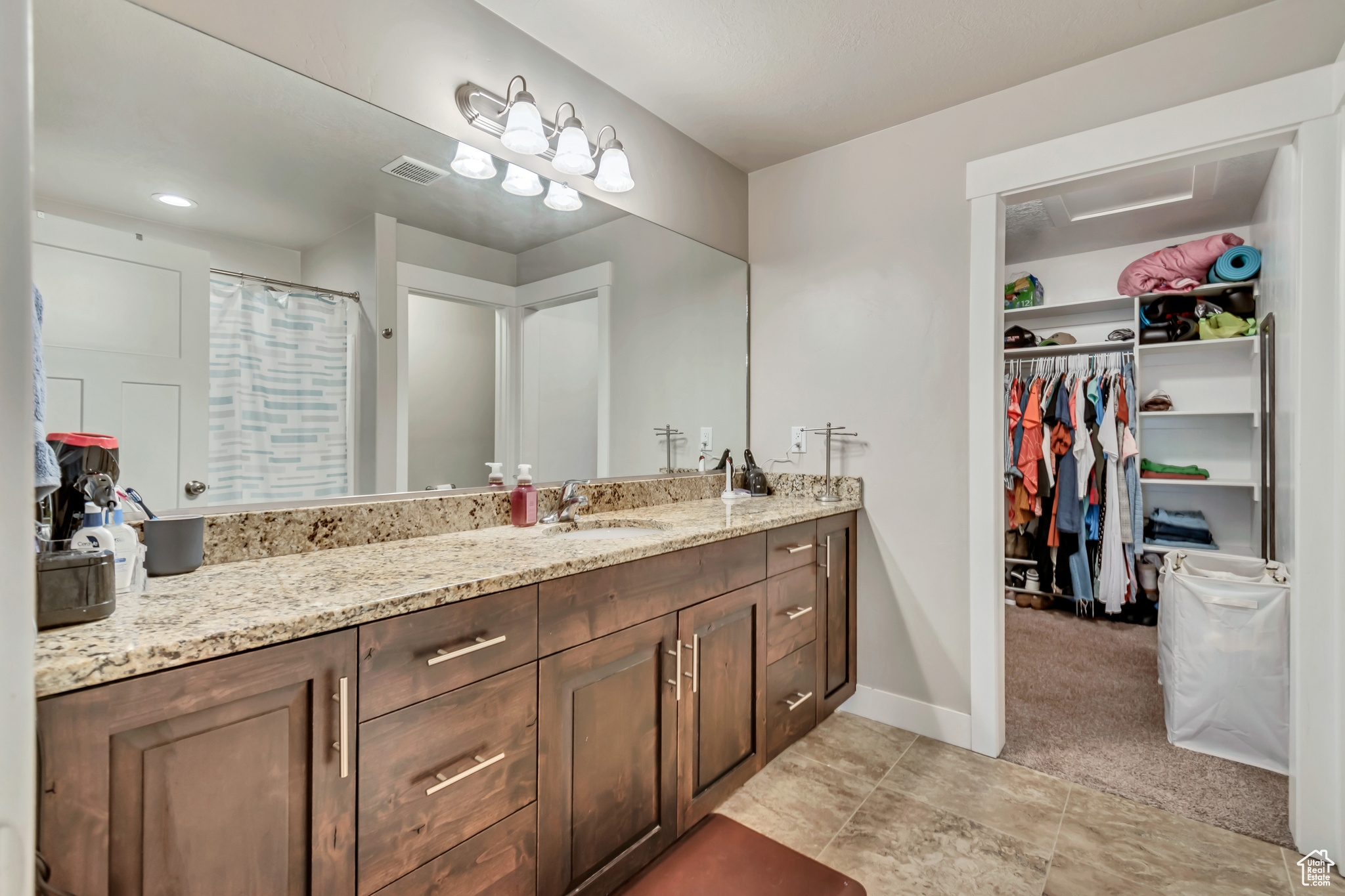 Bathroom featuring tile patterned flooring and vanity