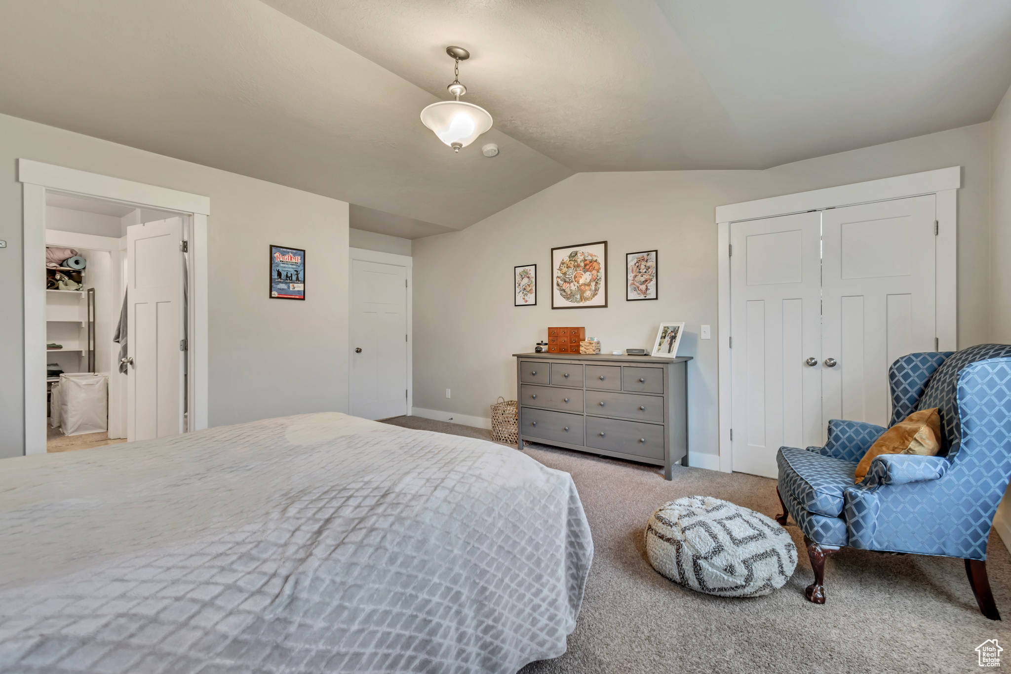 Bedroom featuring carpet floors, lofted ceiling, and a closet