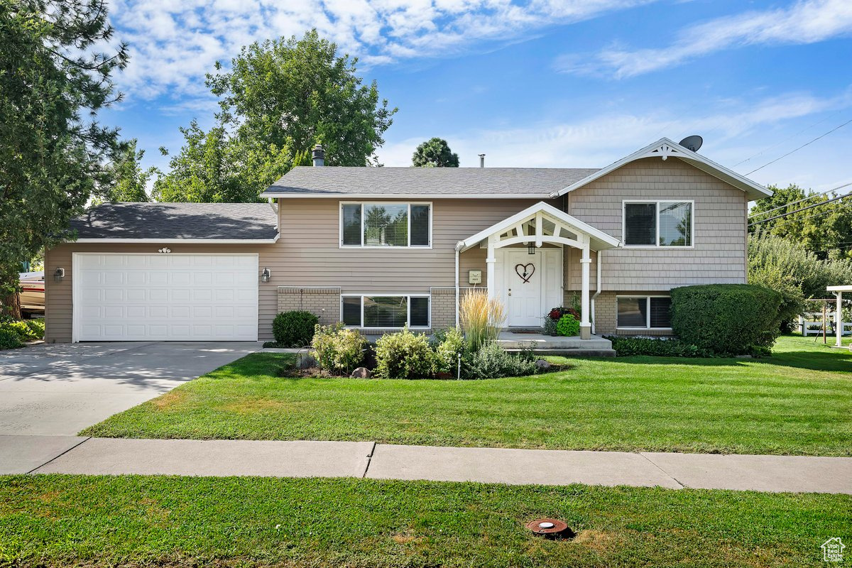 Split foyer home with a front yard and a garage