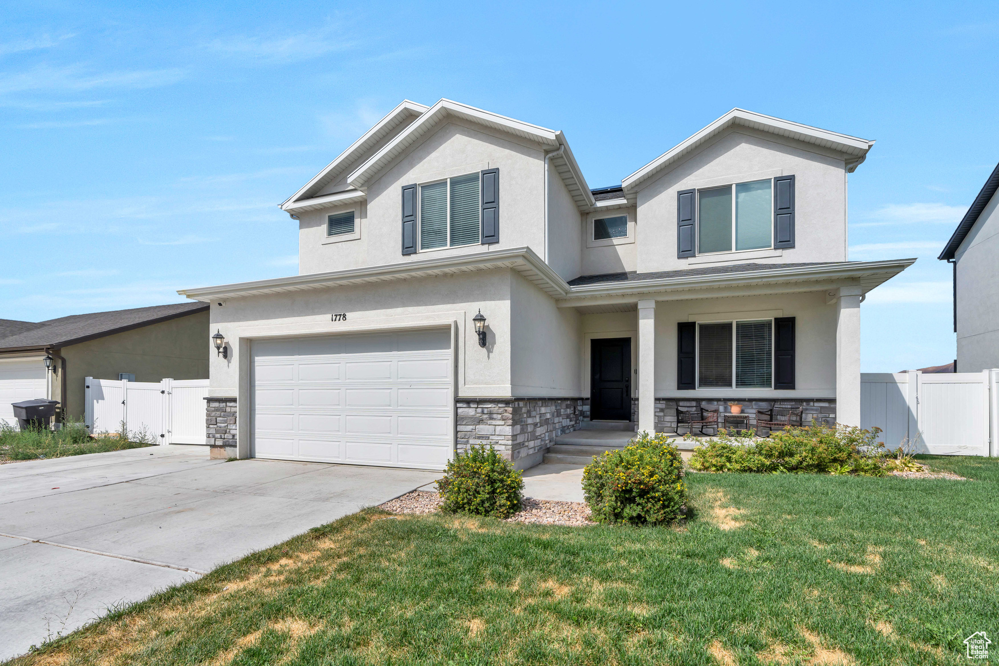 View of front of home with a garage and a front yard