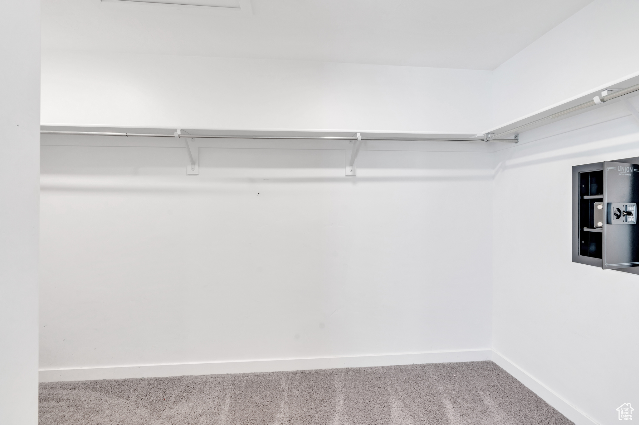 Walk in closet featuring carpet floors and electric panel