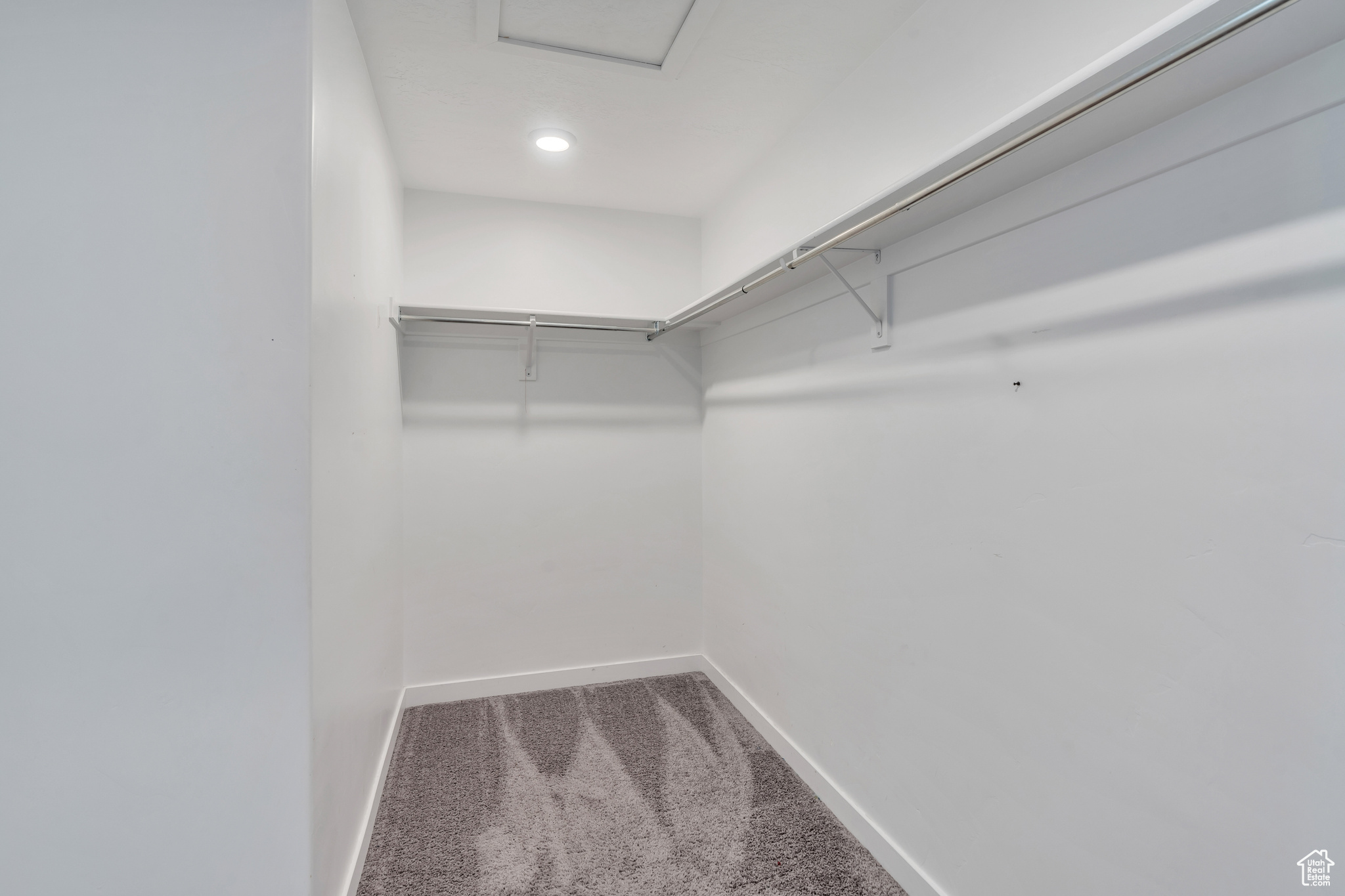 Spacious closet with carpet