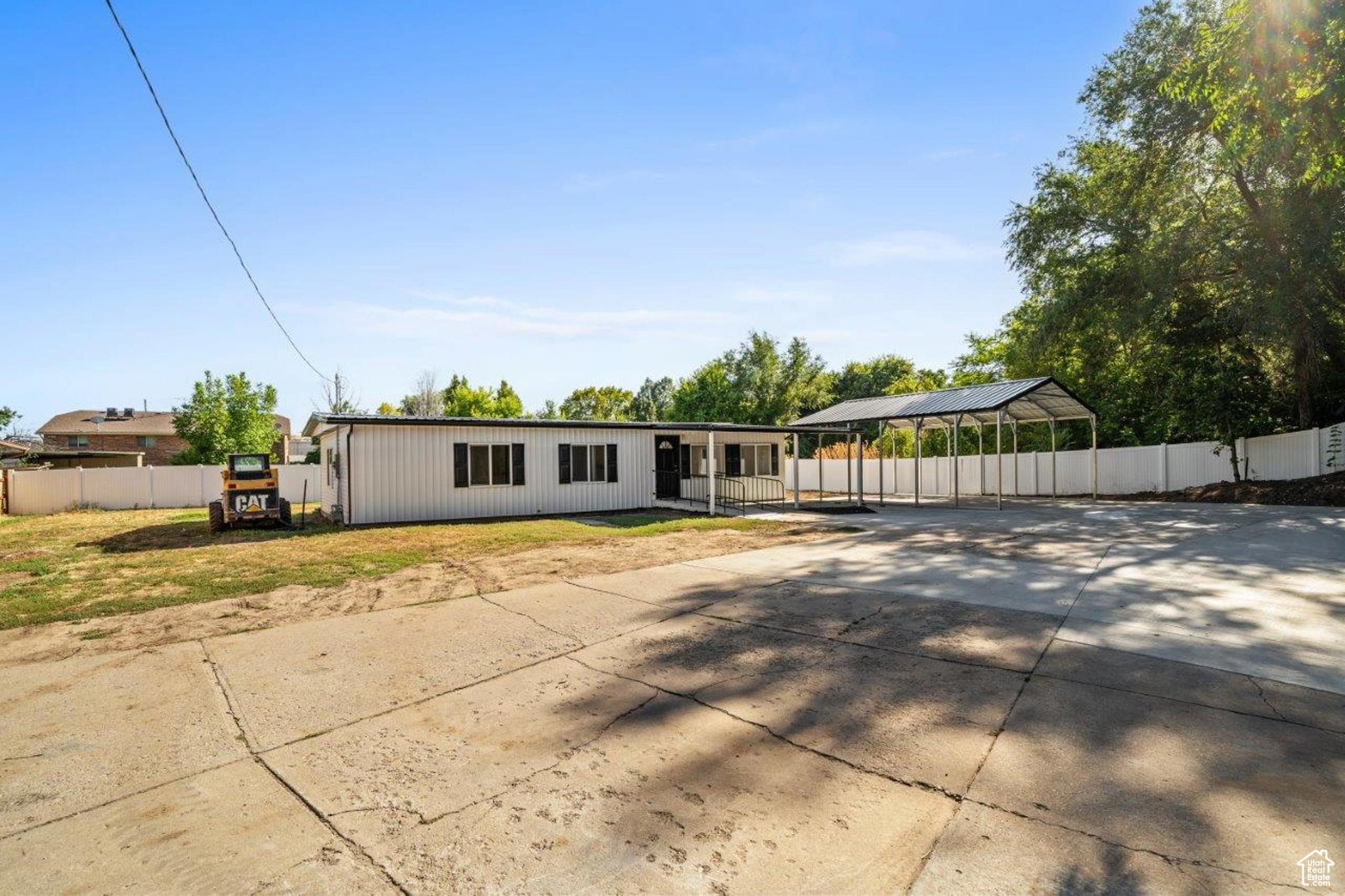 View of front of property with a front lawn and a carport