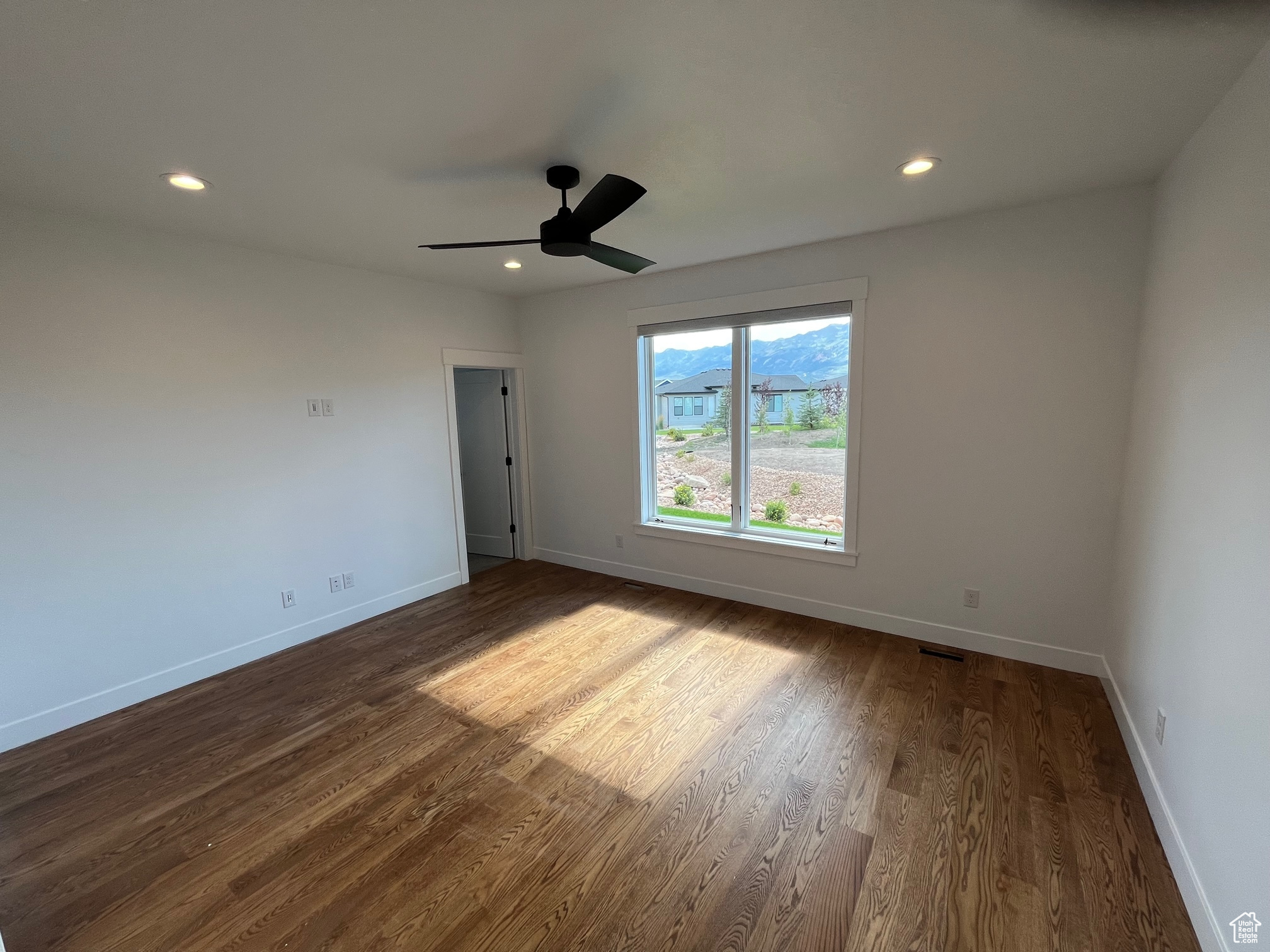 Spare room featuring ceiling fan and hardwood / wood-style floors