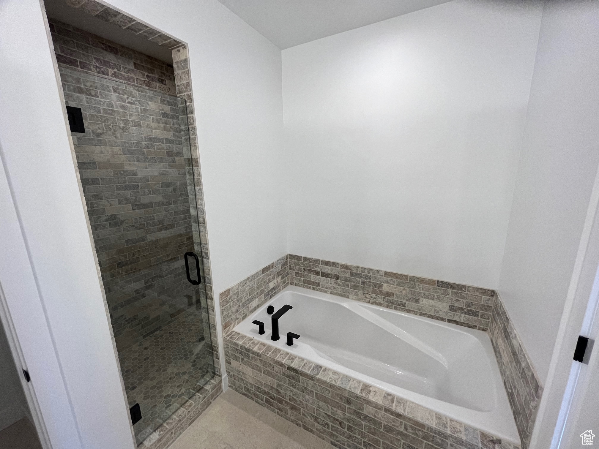 Bathroom featuring shower with separate bathtub and tile patterned floors